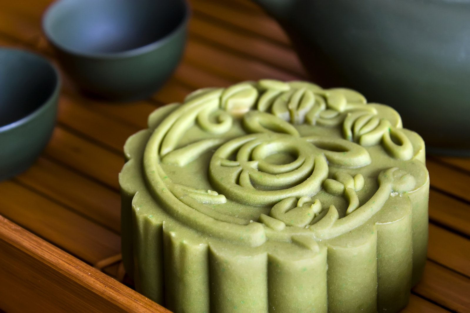 green mooncake on wooden table