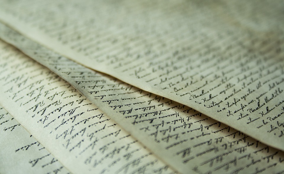 pages of aged paper with neat, cursive handwriting on the pages