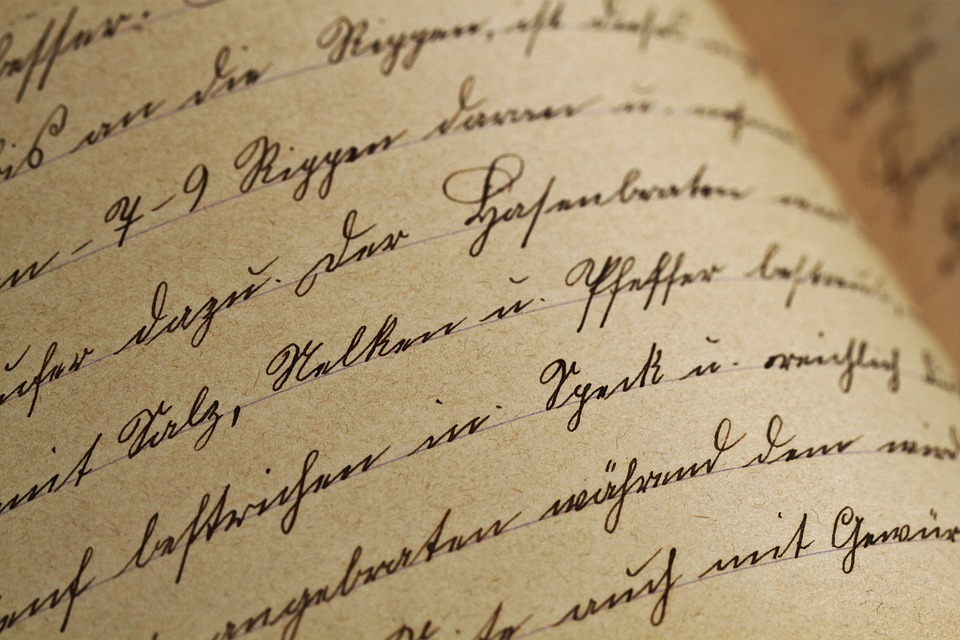 an old book has handwritten text in a copperplate-esque style
